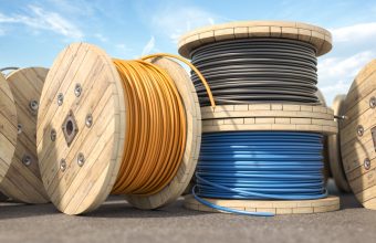 Wire electric cable of different colors on wooden coil or spool